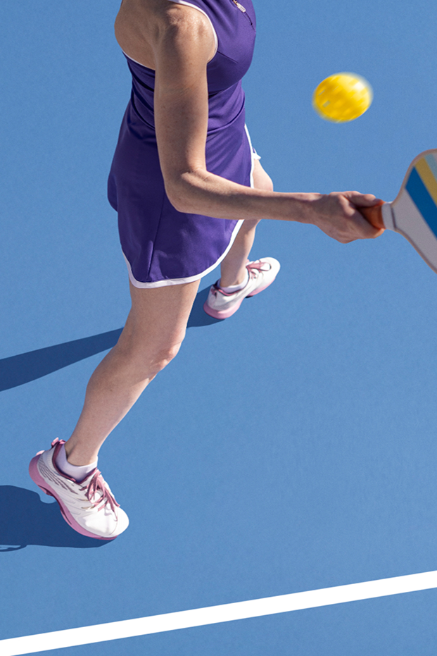 A woman playing pickleball